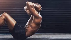 Athlete in hollow body hold on training floor
